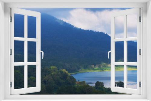 Fototapeta Naklejka Na Ścianę Okno 3D - View of a lake surrounded by volcanic mountains, tropical landscape with dramatic clouds in the sky.  Lake and mountain view from a hill. Forest on the shore of a lake. Nature background.