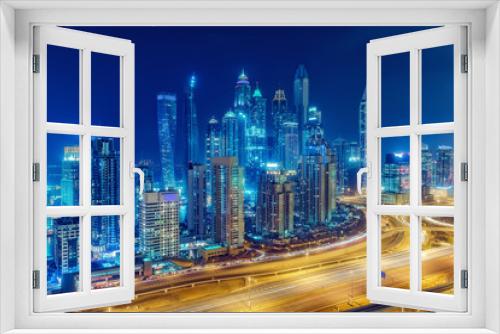 Fototapeta Naklejka Na Ścianę Okno 3D - Scenic nighttime skyline of big modern city with illuminated skyscrapers. Aerial view of Dubai Marina, UAE. Multicolored travel background.