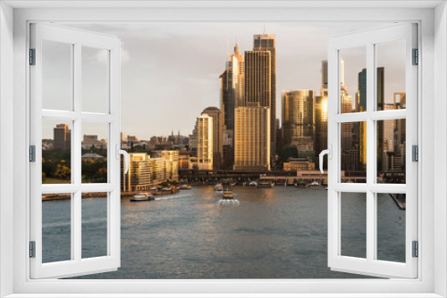 Fototapeta Naklejka Na Ścianę Okno 3D - Stunning aerial view of the sunset over the Sydney business district skyline and the Circular Quay harbor in the Sydney bay in Australia largest city.