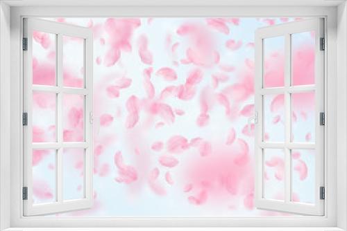 Sakura petals falling down. Romantic pink flowers gradient. Flying petals on blue sky square backgro