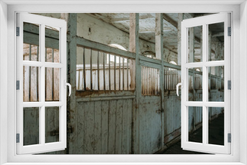 Fototapeta Naklejka Na Ścianę Okno 3D - Inside old wooden stable or barn with horse boxes, corridor