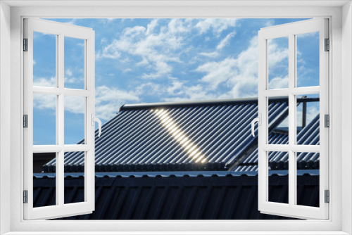 Fototapeta Naklejka Na Ścianę Okno 3D - Vacuum solar water heating system on the house roof.