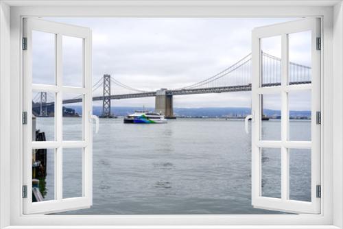 Fototapeta Naklejka Na Ścianę Okno 3D - A ferry in the bay and a view of the bridge, San Francisco, USA