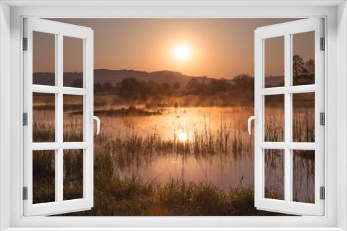 Fototapeta Naklejka Na Ścianę Okno 3D - Misty Golden Sunrise Reflecting over Lake in Spring.