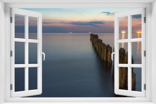 Fototapeta Naklejka Na Ścianę Okno 3D - smooth sea surface and breakwaters in twilight on long exposure