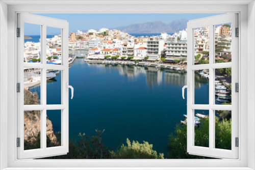 Fototapeta Naklejka Na Ścianę Okno 3D - Agios Nikolaos. Crete. Buildings on the shore of Voulismeni Lake and boats at the pier