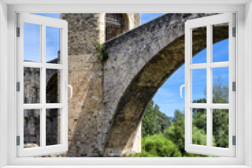 Fototapeta Naklejka Na Ścianę Okno 3D - Spain, Catalonia, Besalu: Panorama view on the famous skyline of old ancient fortified Spanish town with bridge, river EL Fluvia, tower, green trees and blue sky in the background - concept history.