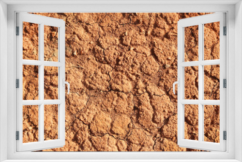 Fototapeta Naklejka Na Ścianę Okno 3D - Dry polluted red stony soil, top view.