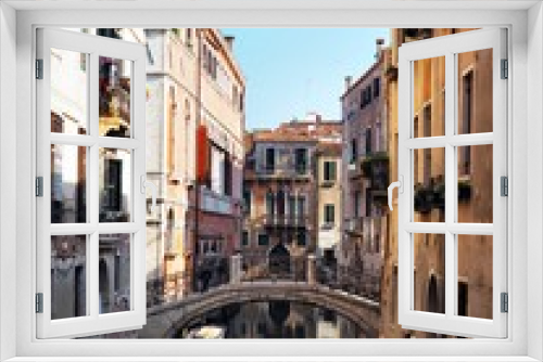 Fototapeta Naklejka Na Ścianę Okno 3D - The canal is surrounded with the bridge by ancient buildings, gondolas and boats in Venice