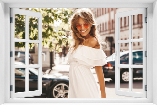 Portrait of beautiful cute blond teenager model with no makeup in summer hipster white dress clothes posing on the street background in sunglasses