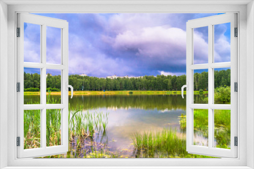 Fototapeta Naklejka Na Ścianę Okno 3D - Natural forest lake with artificial sandy beach for free public leisure activities. Moscow residential suburb, Zarya district, Balashikha. Russia.