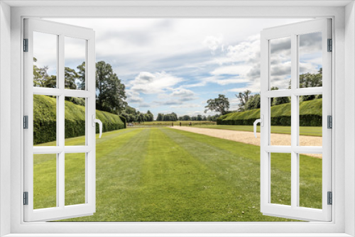 Fototapeta Naklejka Na Ścianę Okno 3D - Beautiful view of a neat lawn with hedges on the sides in blickling hall, on a sunny day