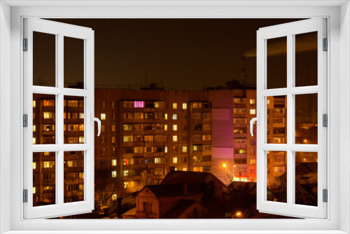 Fototapeta Naklejka Na Ścianę Okno 3D - Photo of buildings at night with factory smoke above them