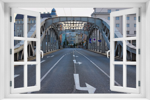 Fototapeta Naklejka Na Ścianę Okno 3D - Milos Sykora bridge in Ostrava. Steel arch bridge over the Ostravice river. Technical monument and sightseeing. Summer evening view. Ostrava, Czech Republic