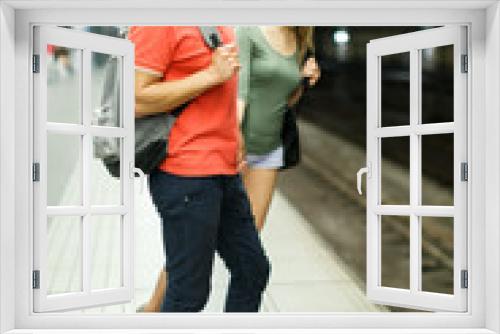 Couple is standing on platform and waiting train