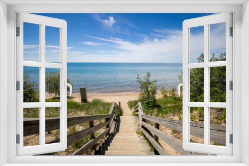 Fototapeta Naklejka Na Ścianę Okno 3D - Stairs To The Beach. Wooden staircase leads to a scenic wide sandy beach on a sunny summer day on the Great Lakes coast. 
