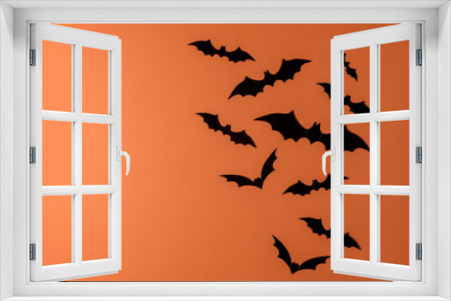 Fototapeta Naklejka Na Ścianę Okno 3D - Halloween holiday minimal top view of bats on orange background. Halloween minimal concept.