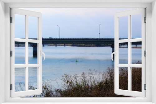 Fototapeta Naklejka Na Ścianę Okno 3D - A bridge over calm Kuma River in winter scenery