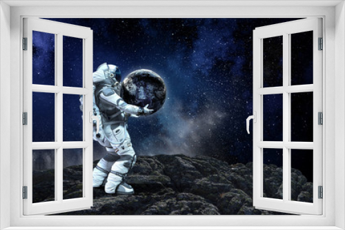 Fototapeta Naklejka Na Ścianę Okno 3D - Spaceman carry big planet. Mixed media