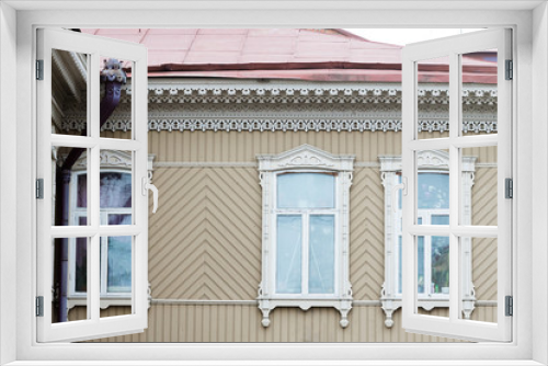 Fototapeta Naklejka Na Ścianę Okno 3D - Carved wooden trim facade. Old historic house. Russian architecture. Chopped house with carved wooden architraves. Tomsk, Russia