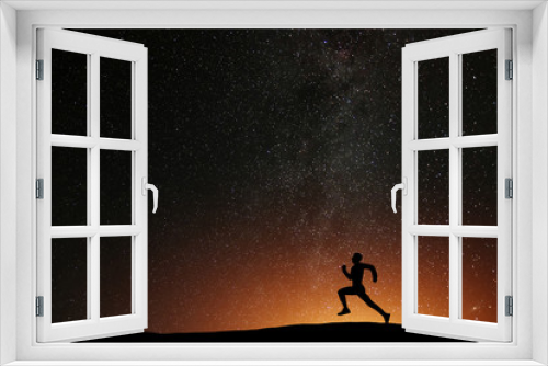 Fototapeta Naklejka Na Ścianę Okno 3D - Runner athlete running on the hill with beautiful starry night background. Silhouette of man jogging workout in dark time, wellness concept.