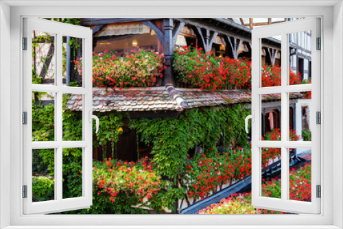 Fototapeta Naklejka Na Ścianę Okno 3D - half timbered house with balconies full of flowers in Strasbourg, France