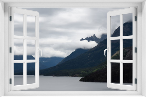 Fototapeta Naklejka Na Ścianę Okno 3D - Misty clouds rise over Upper Waterton Lake mountain peaks in Waterton Lakes National Park, Canada