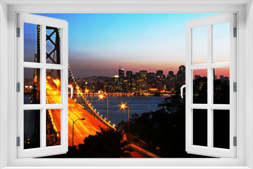 Fototapeta Naklejka Na Ścianę Okno 3D - San Francisco Bay Bridge at sunset from Treasure Island - shows traffic and city lights