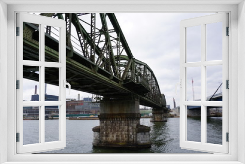 Fototapeta Naklejka Na Ścianę Okno 3D - Linz an der Donau, Industriehafen und Brücken, fotografiert von einem Flusskreuzfahrtschiff im Frühjahr