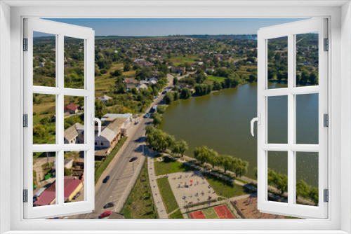 Fototapeta Naklejka Na Ścianę Okno 3D - Aerial view of typical village and lake.