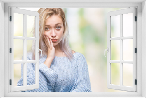 Young blonde woman wearing winter sweater over isolated background thinking looking tired and bored with depression problems with crossed arms.