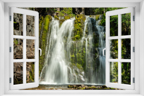 Fototapeta Naklejka Na Ścianę Okno 3D - Beautiful waterfall flowing down a green rock wall