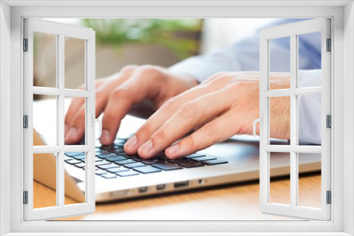 Fototapeta Naklejka Na Ścianę Okno 3D - Closeup of a Businessman Typing on a Laptop