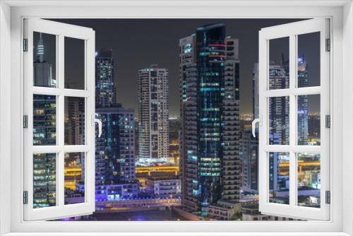 Fototapeta Naklejka Na Ścianę Okno 3D - Water canal on Dubai Marina skyline at night timelapse.