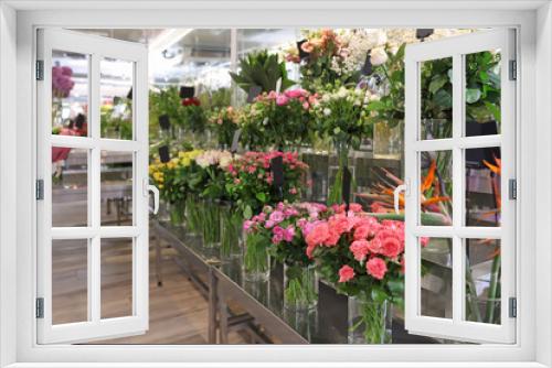 Fototapeta Naklejka Na Ścianę Okno 3D - Assortment of beautiful flowers in shop. Florist's workplace