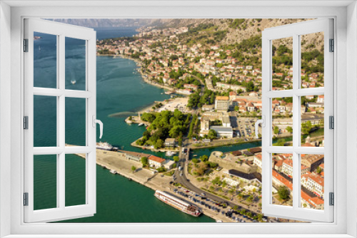 Fototapeta Naklejka Na Ścianę Okno 3D - Panoramic aerial view of the red tiled roofs of the old town of Kotor and Kotor Bay