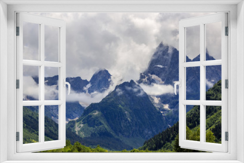 Fototapeta Naklejka Na Ścianę Okno 3D - Peak of the mountain with glaciers against the background of clouds and sky. Caucasian ridge, Russia.