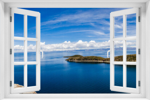 Fototapeta Naklejka Na Ścianę Okno 3D - Panoramic on Isla del Sol with a blue Titikaka Lake, stones, an island and a few turists on a sunny day