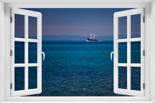 Fototapeta Naklejka Na Ścianę Okno 3D - Fishing boat on the blue Aegean Sea in Samothrace Island in Greece with sea gulls surrounding it