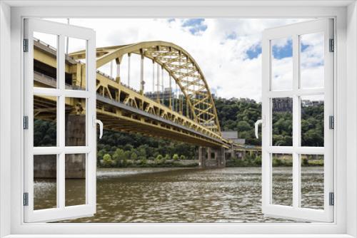 Fototapeta Naklejka Na Ścianę Okno 3D - Large yellow bridge crossing calm river