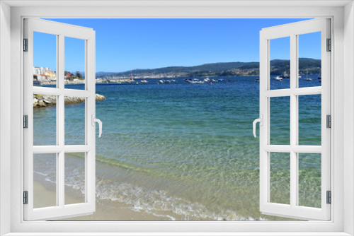 Fototapeta Naklejka Na Ścianę Okno 3D - Bay with small coastal village and beach. Clear water with turquoise, green and blue colours. Galicia, Rias Baixas, Spain.