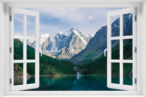 Fototapeta Naklejka Na Ścianę Okno 3D - Wonderful giant snowy mountains. Creek flows from glacier into mountain lake. Reflection in water in highlands. White clear snow on ridge. Amazing atmospheric landscape of majestic nature.