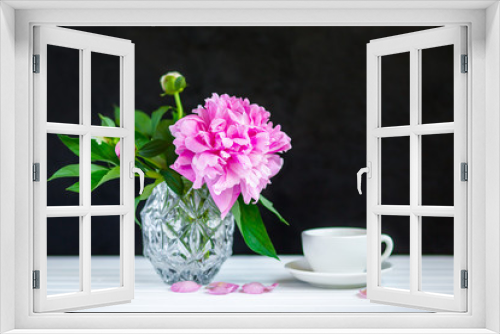 Fototapeta Naklejka Na Ścianę Okno 3D - Cup of tea and peonies in a vase on the table.