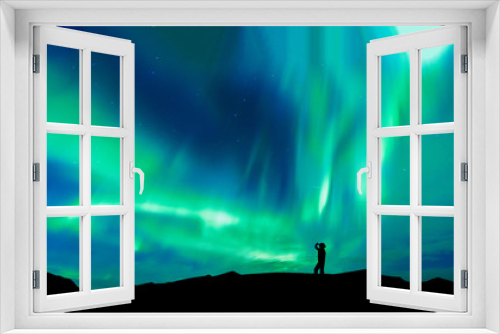 Fototapeta Naklejka Na Ścianę Okno 3D - Aurora borealis with silhouette standing man on the mountain.Freedom traveller journey concept