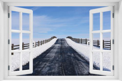 Fototapeta Naklejka Na Ścianę Okno 3D - Winter Scene of Road with Fence - looking up small hill with blue skies