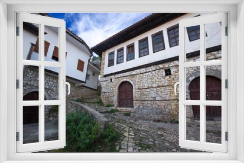 Fototapeta Naklejka Na Ścianę Okno 3D - Old town Berat, historic city in the south of Albania.Tiny stone streets with white stone houses built in ottoman style. also called city of a thousand windows. World Heritage Site by UNESCO