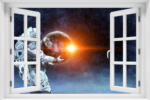 Fototapeta Naklejka Na Ścianę Okno 3D - Spaceman carry big planet. Mixed media