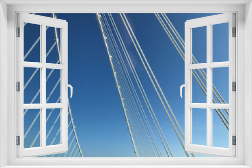 Fototapeta Naklejka Na Ścianę Okno 3D - detail close up o fwhite steel bridge suspension wires against blue sky