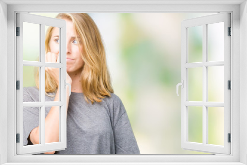 Beautiful young woman wearing oversize casual t-shirt over isolated background looking stressed and nervous with hands on mouth biting nails. Anxiety problem.