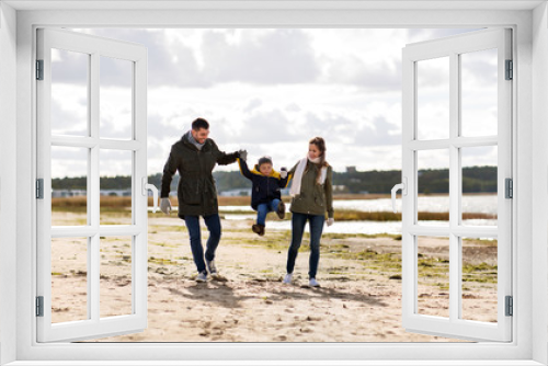 Fototapeta Naklejka Na Ścianę Okno 3D - family, leisure and people concept - happy mother, father and little son walking along autumn beach